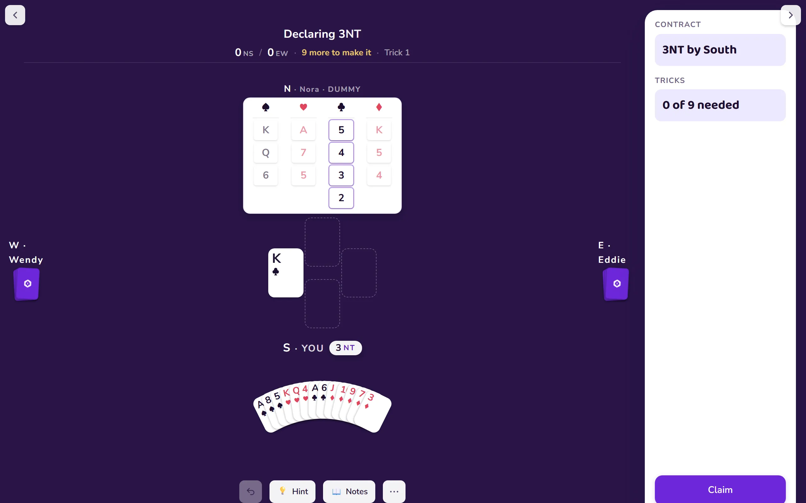 A full deal in play on the Bridge Unlocked table, cards face up in the centre